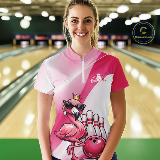 Female model wearing a pink bowling quarter-zip shirt at a bowling lane with a crowned flamingo in sunglasses and a bowling ball design.