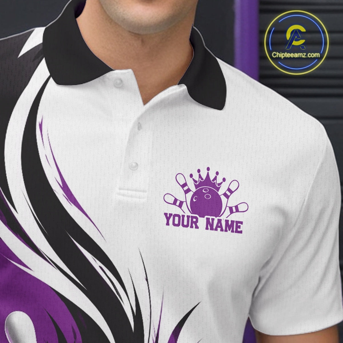 Close-up of the left chest on a white, black, and purple bowling polo shirt featuring a flaming bowling ball striking pins graphic.