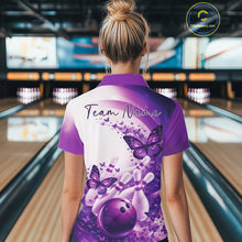 Load image into Gallery viewer, Female model wearing a purple bowling polo with butterfly artwork and bowling graphics, back view at the bowling lane