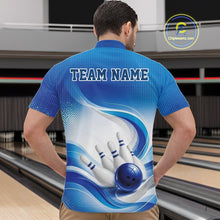 Load image into Gallery viewer, Male model standing in a bowling lane wearing a white and blue bowling quarter-zip shirt featuring abstract wave lines and a glossy bowling ball striking pins on the front.
