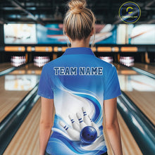 Load image into Gallery viewer, Female model standing in a bowling lane showing the back of a white and blue bowling quarter-zip shirt with abstract wave lines and a glossy bowling ball striking pins graphic.