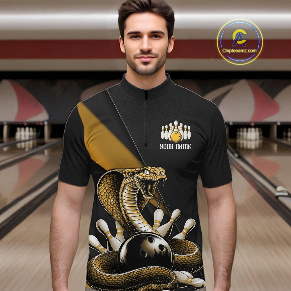 Male model wearing a black bowling quarter-zip in a bowling lane with yellow cobra artwork and bowling pin graphics.