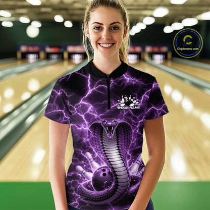Female model at a bowling alley wearing a quarter-zip with a purple cobra wrapped around a bowling ball against lightning effects.