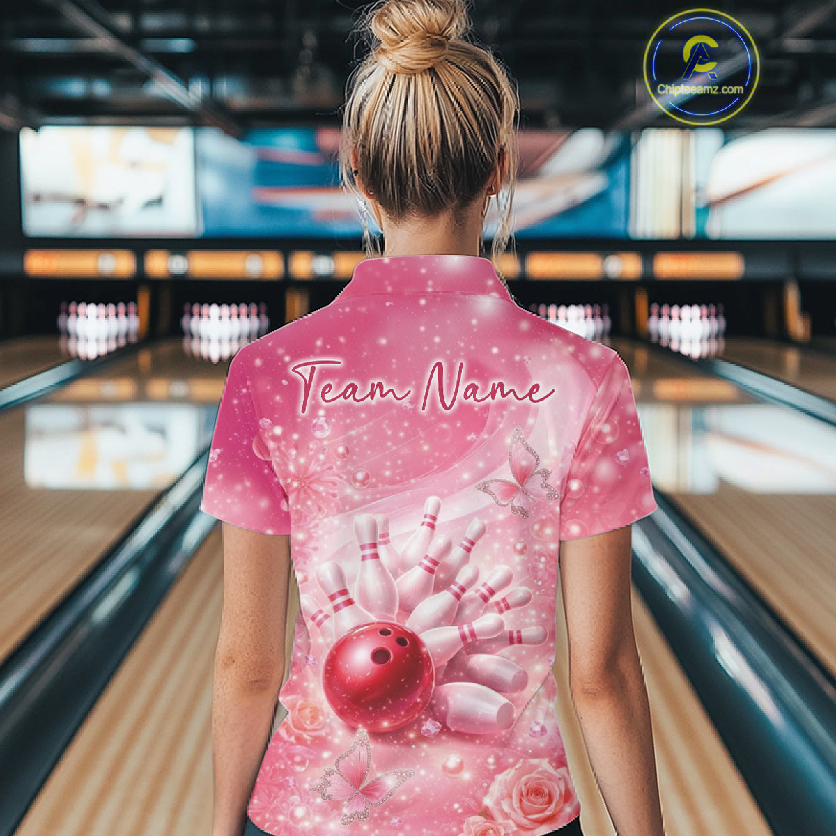 Back view female model wearing polo shirt with flaming bowling ball crashing into pins purple fiery bowling graphics