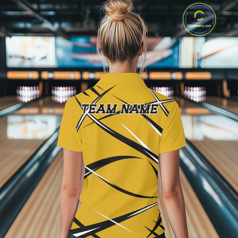 Back view of a female bowler wearing a yellow, black, and white bowling polo shirt in a bowling lane setting