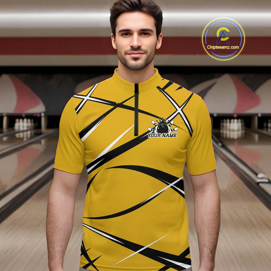 Front view of a male bowler in a bowling lane wearing a yellow, black, and white bowling quarter zip shirt
