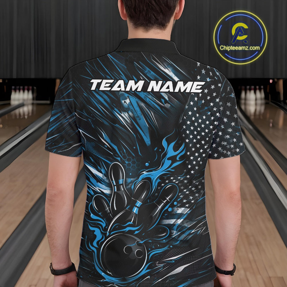 Back view of a male model in a bowling alley wearing a black and blue polo shirt featuring a flaming bowling ball and pin motif.