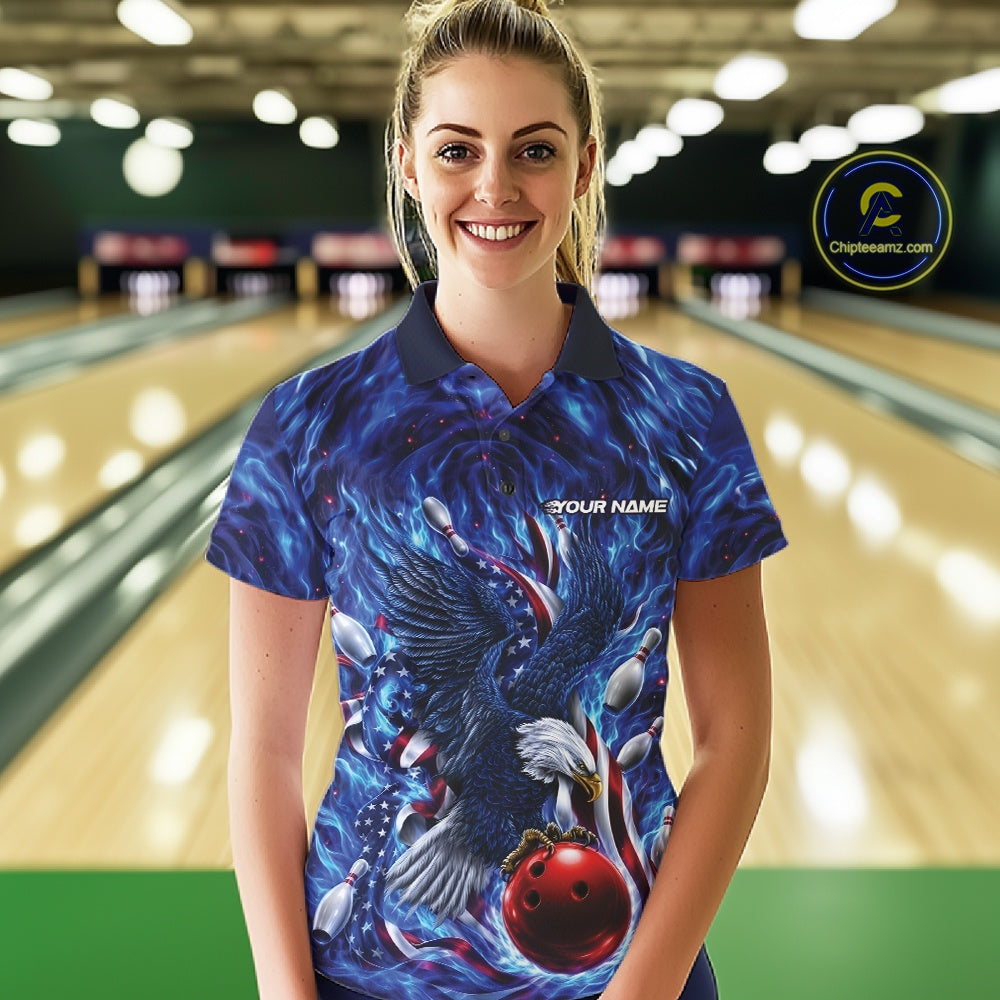 Female model front view at the bowling lane wearing a polo shirt with eagle motif around a bowling ball, flag details, and pins.