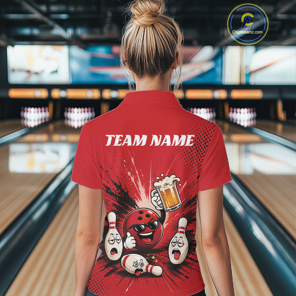 A woman viewed from behind wearing a red bowling-themed short-sleeve polo shirt with a cartoon bowling ball and pins graphic and the text 'TEAM NAME' on the back, standing in a bowling alley.