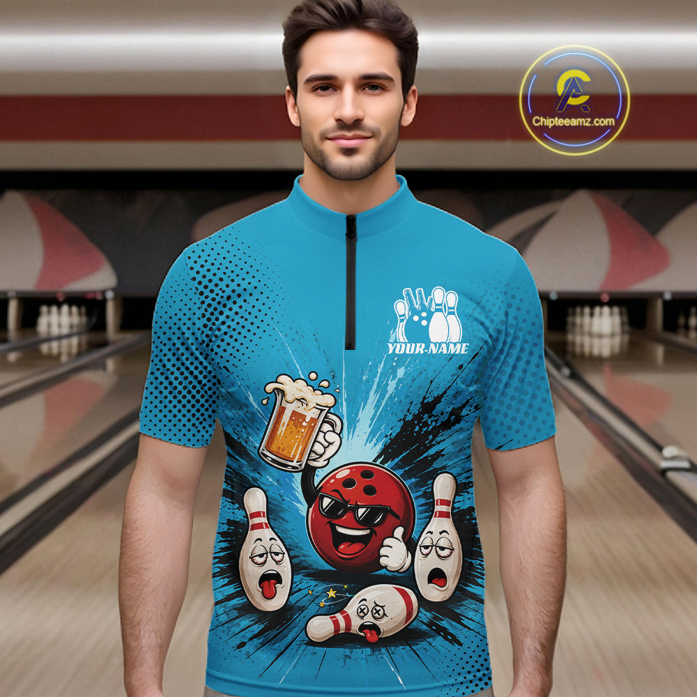 A man wearing a bright blue short-sleeve zip-front jersey with a bowling-themed cartoon graphic on the front, standing in a bowling alley. The jersey features a black zipper, white bowling pins, a red bowling ball, and a beer mug.