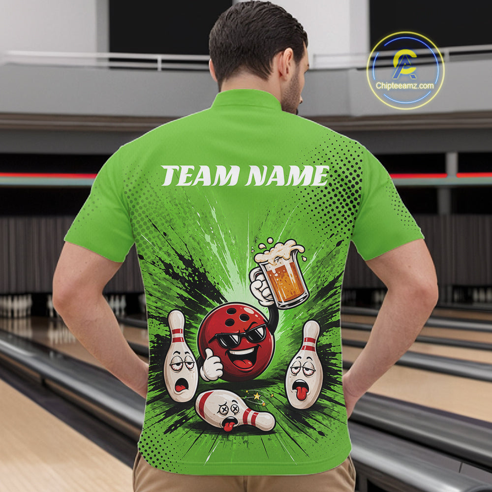A man viewed from behind wearing a bright green short-sleeve bowling-themed shirt with a large back graphic featuring a red bowling ball, bowling pins, a beer mug, and the text 'TEAM NAME'. The background shows a blurred bowling alley interior.