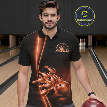 In bowling lane front view male model wearing bowling polo shirt, black base with orange bowling ball and pins graphic, energetic sports lighting