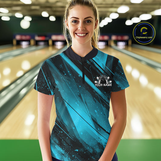 Person wearing a custom bowling shirt with a logo and text in a bowling alley.