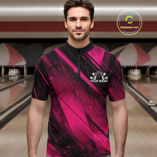 Man wearing a pink and black bowling shirt with a bowling alley in the background