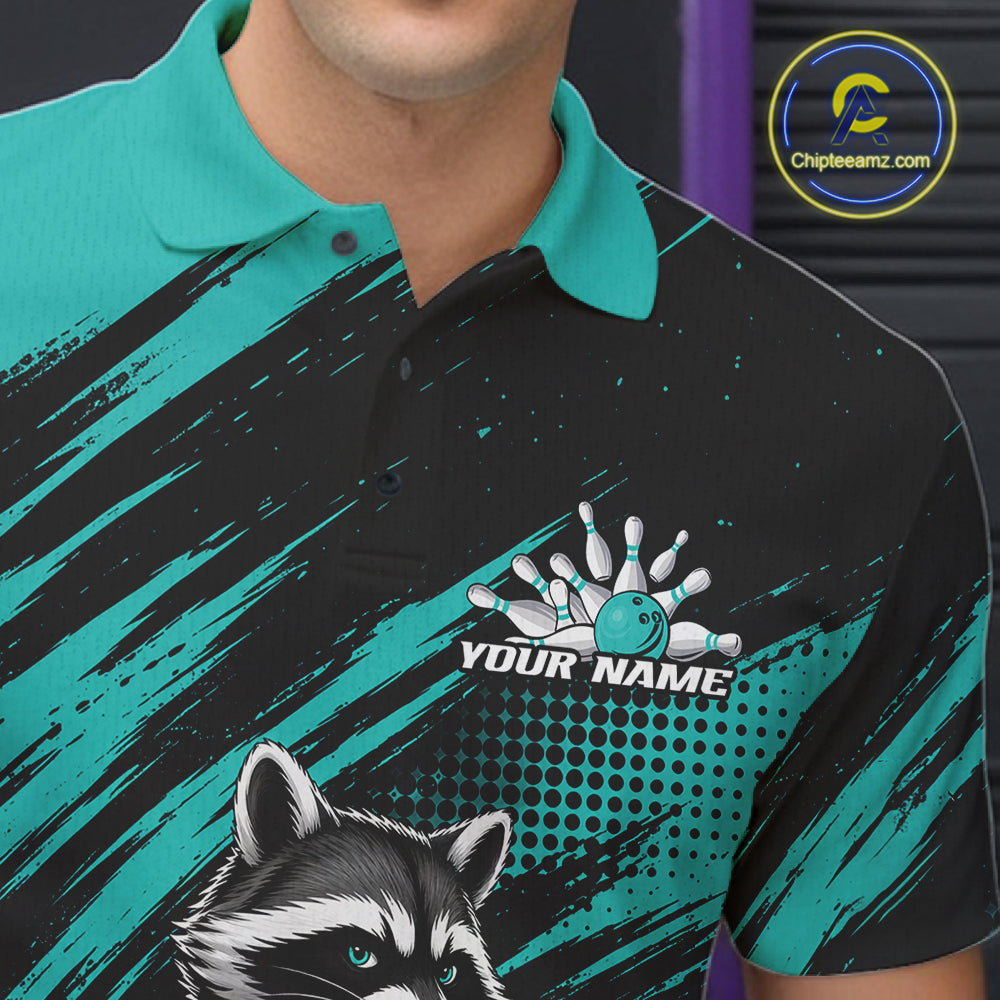A close-up of a man wearing a custom bowling-themed polo shirt. The shirt features a black and teal color scheme with a raccoon graphic on the lower left, a bowling pin and ball design with the placeholder text 'YOUR NAME' 