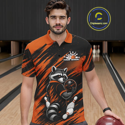 A man wearing a custom bowling polo shirt with a raccoon graphic, standing in a bowling alley holding a bowling ball. The shirt features a black and orange brushstroke pattern with a raccoon holding a bowling ball and pins, and a custom name printed on the chest.
