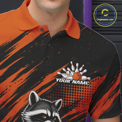 A close-up of a man wearing a custom bowling-themed polo shirt. The shirt features a black and orange abstract brushstroke pattern, a raccoon graphic at the bottom, and a customizable bowling design with the text 'YOUR NAME' on the chest.