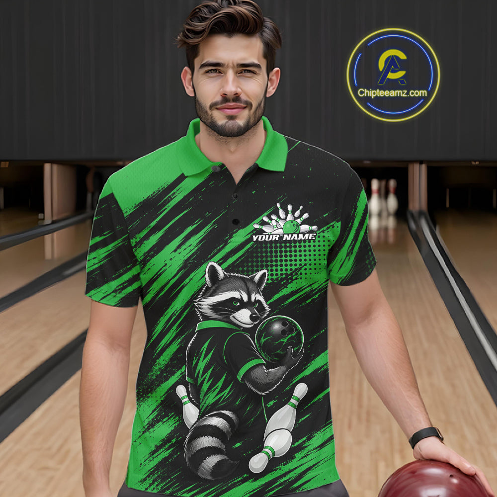 A man wearing a custom bowling polo shirt with a raccoon graphic, standing in a bowling alley holding a bowling ball. The shirt features a black and green brushstroke pattern with a raccoon holding a bowling ball and pins, and a custom name printed on the chest.