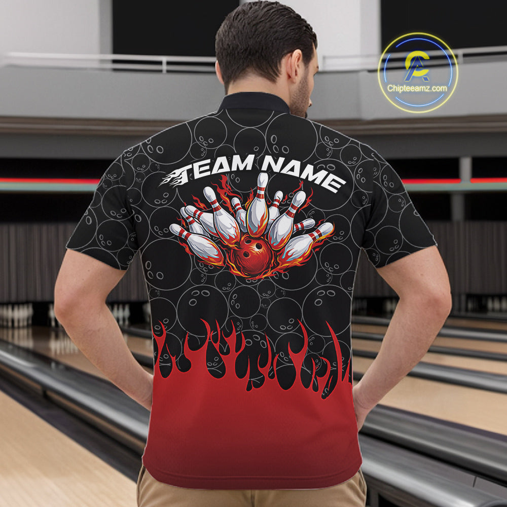Male model inside a bowling venue wearing black quarter zip shirt, front view featuring bowling ball pattern with red flames rising and striking bowling action graphics