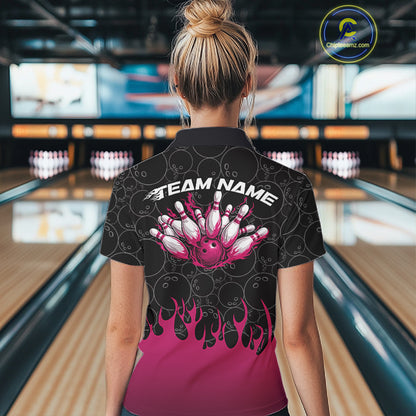 Back view of a female model in a bowling lane wearing a black polo shirt featuring vibrant pink flames and bowling ball pattern with dynamic sports styling.