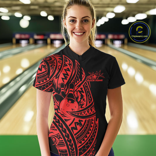 Female model wearing a black and red bowling quarter-zip shirt at the lane with Polynesian-style bowling accents.