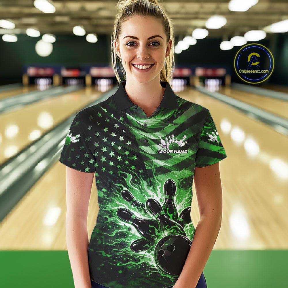 Female model wearing a black bowling polo shirt at the bowling lane with green flame bowling artwork and distressed American flag accents.