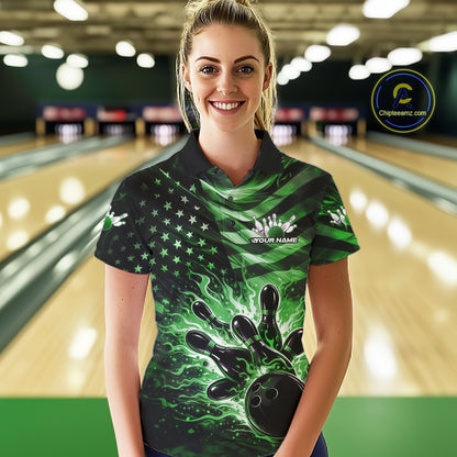 Female model wearing a black bowling polo shirt at the bowling lane with green flame bowling artwork and distressed American flag accents.