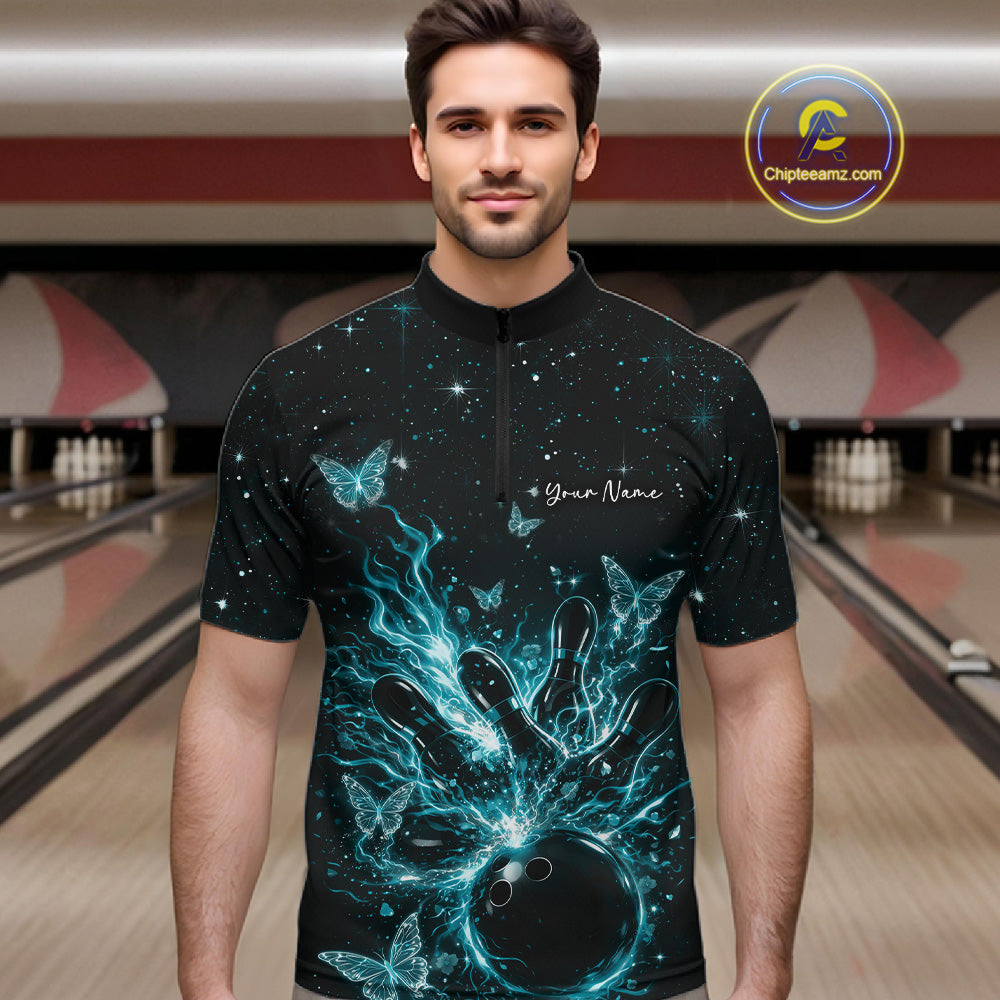 Male model in a black and turquoise blue bowling quarter-zip shirt at the lane with glowing butterfly strike graphics.