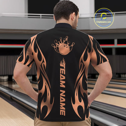 Front view of male model at bowling lane wearing black quarter zip shirt showcasing rose gold tribal flame artwork with bowling ball hitting pins in dynamic motion.