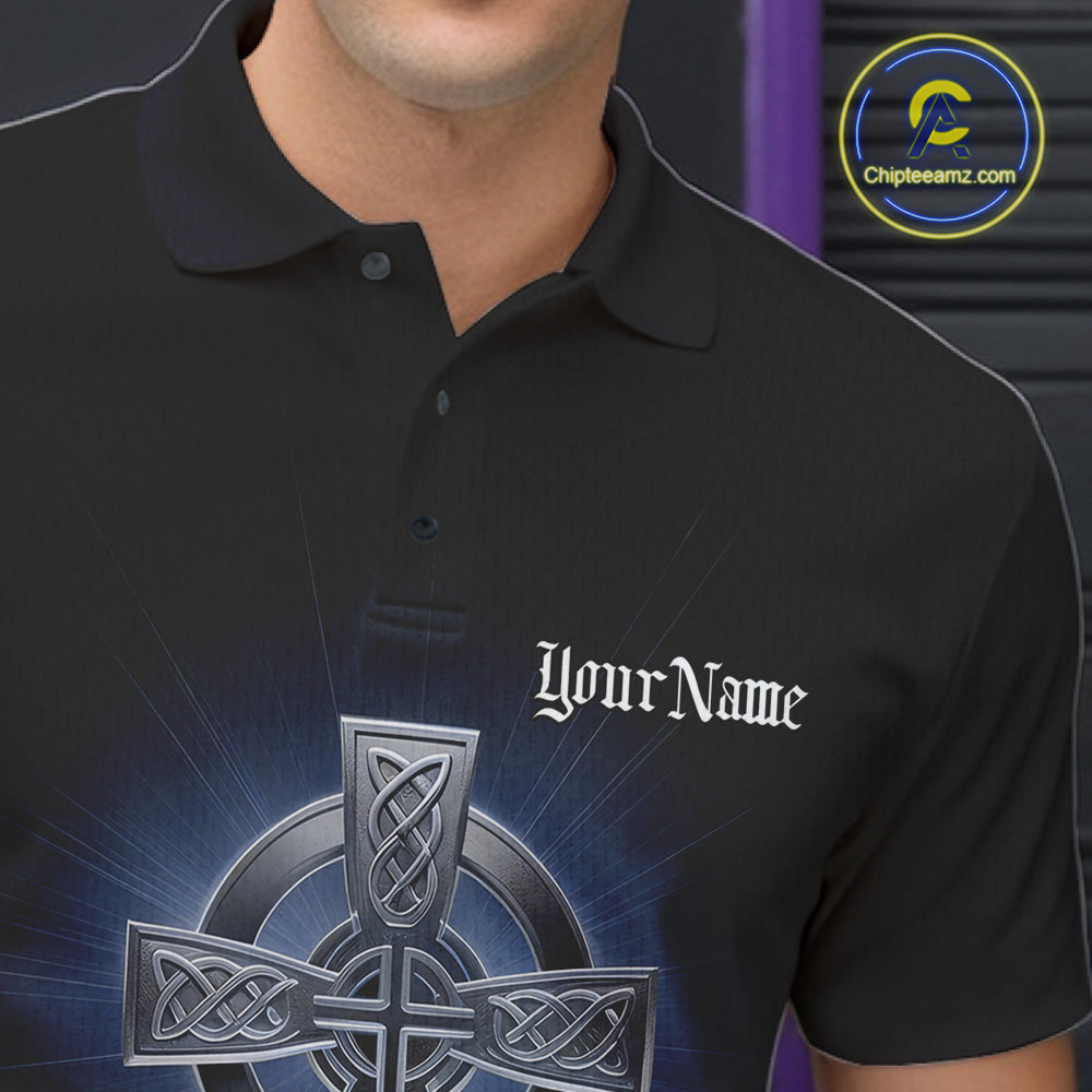 Close-up detail of left chest on black bowling polo shirt showing blue Celtic cross with bowling ball exploding into pins illustration