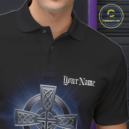 Close-up detail of left chest on black bowling polo shirt showing blue Celtic cross with bowling ball exploding into pins illustration