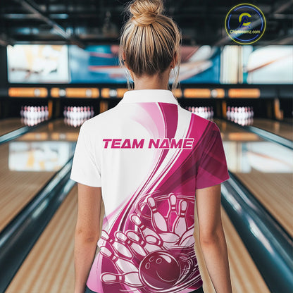 Back view of a female model in a bowling venue wearing a white and pink polo shirt, showcasing a dynamic curved bowling ball hitting pins design.