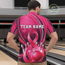 Load image into Gallery viewer, Front view of a male model in a pink and black bowling quarter zip featuring breast cancer awareness ribbons and bowling graphics