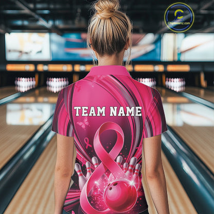 Female model in a pink and black bowling quarter zip with breast cancer awareness ribbons and bowling artwork, back view at the bowling lane