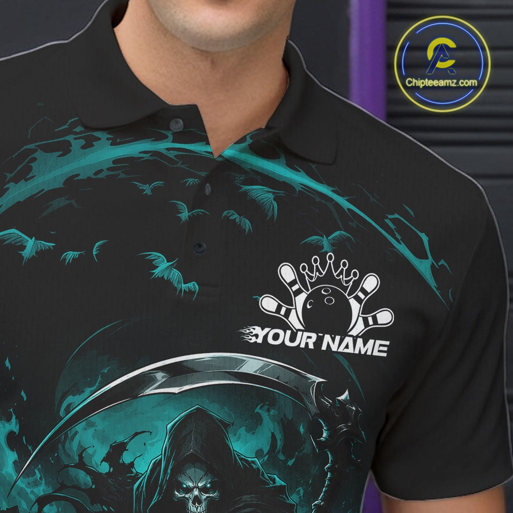 Close-up of the left chest on a black and cyan blue bowling polo shirt featuring a grim reaper commanding a blazing bowling ball crashing into scattered pins through swirling flames.