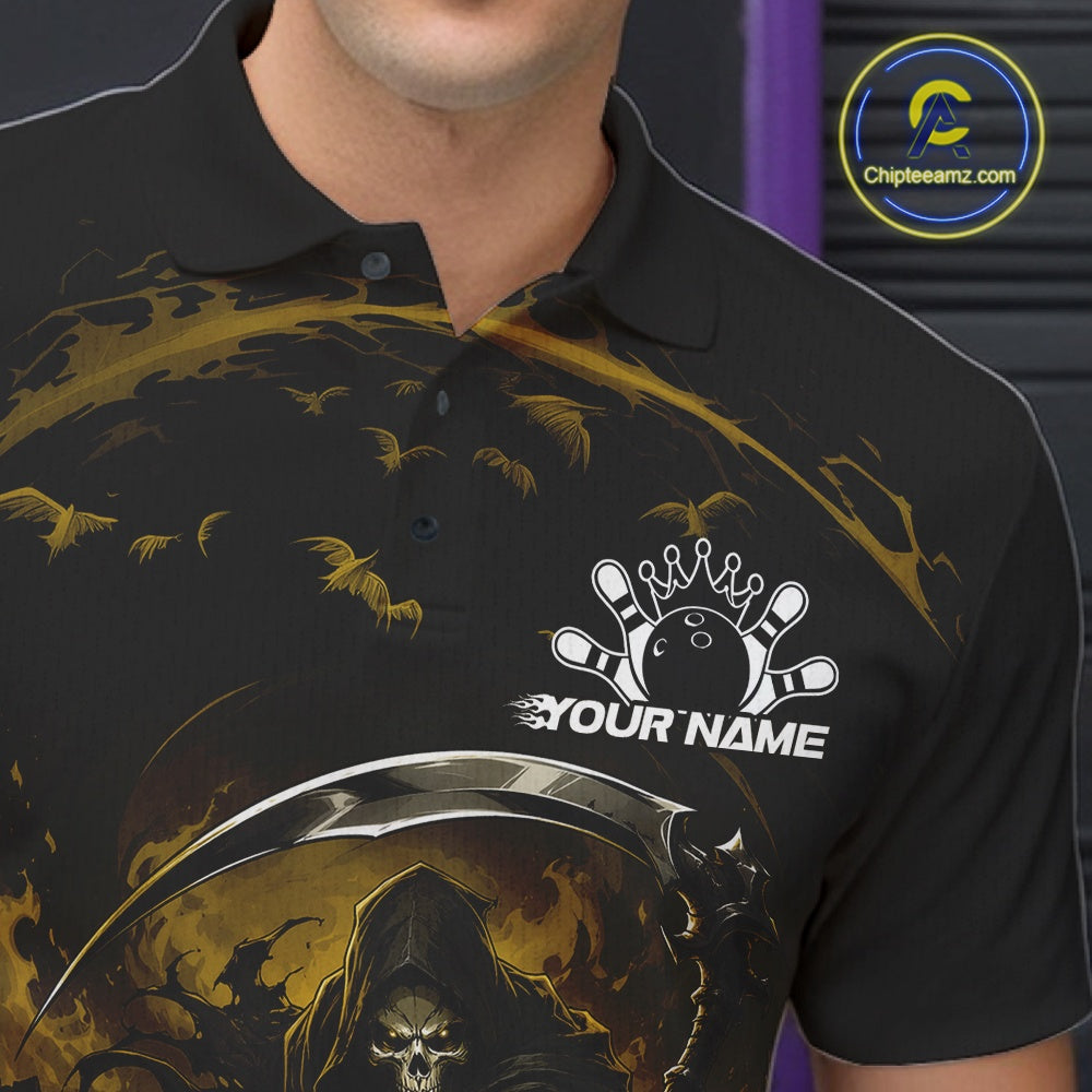 Close-up of the left chest on a black and yellow bowling polo shirt featuring a grim reaper reaching through swirling flames to command a blazing bowling ball crashing into scattered pins.