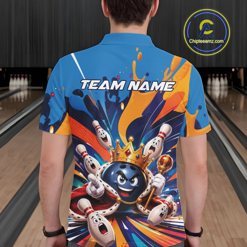 Back view of a male model wearing a bowling polo shirt featuring a crowned cartoon bowling ball holding a royal scepter with animated bowling pins, colorful paint splashes, and festive artwork in a bowling lane.