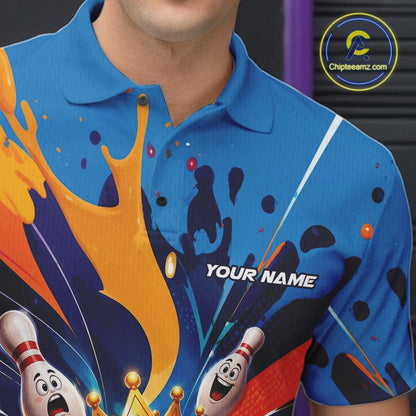 Close-up of the left chest on a bowling polo shirt featuring a crowned cartoon bowling ball holding a royal scepter with cheering animated bowling pins and colorful paint splashes.