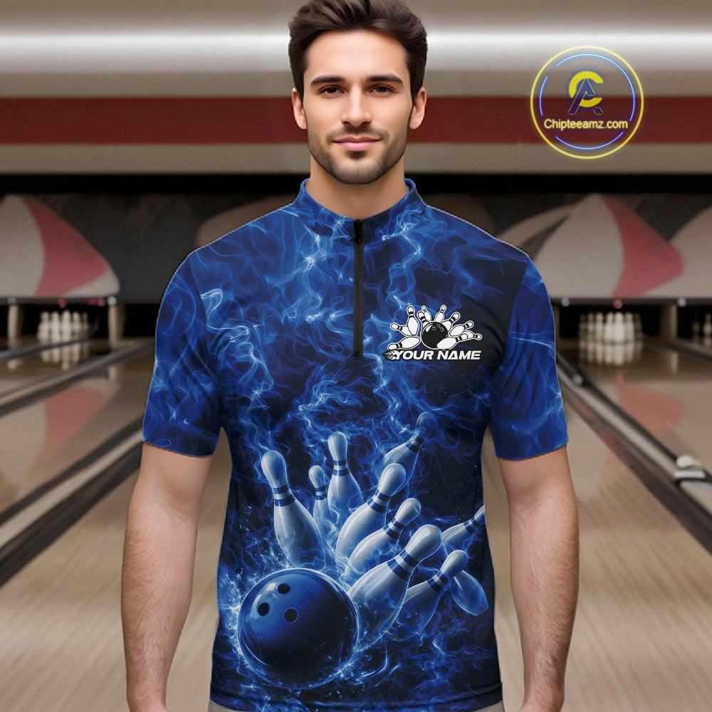 Male model wearing a bowling quarter-zip in a bowling alley with blue bowling ball artwork and dramatic flames.