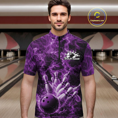 Male model at a bowling alley wearing a quarter-zip decorated with a purple bowling ball and fiery bowling strike graphics.