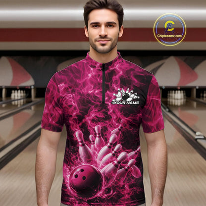 Male model wearing a bowling quarter-zip in a bowling lane with a pink bowling ball striking pins and fiery graphics.