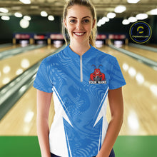 Load image into Gallery viewer, Front view of a happy female model in a bowling alley wearing a blue custom quarter-zip bowling shirt with a funny aggressive crawfish holding a bowling ball in a sportswear-style design.