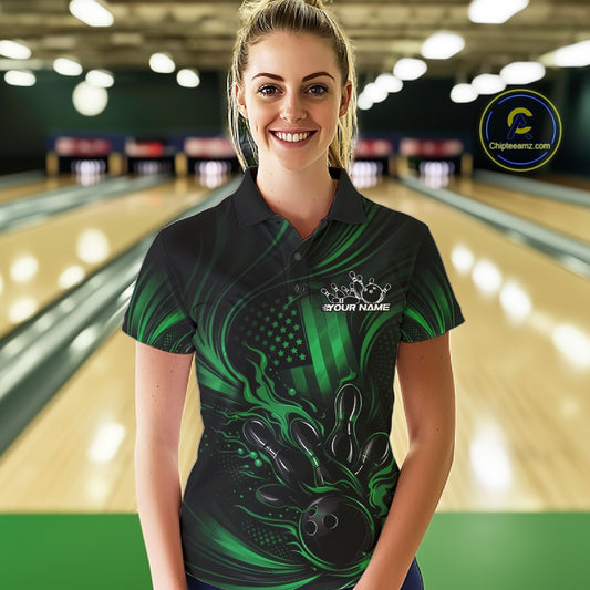 Female model at a bowling lane wearing a black and green bowling polo shirt with patriotic bowling strike artwork and distressed flag graphics.