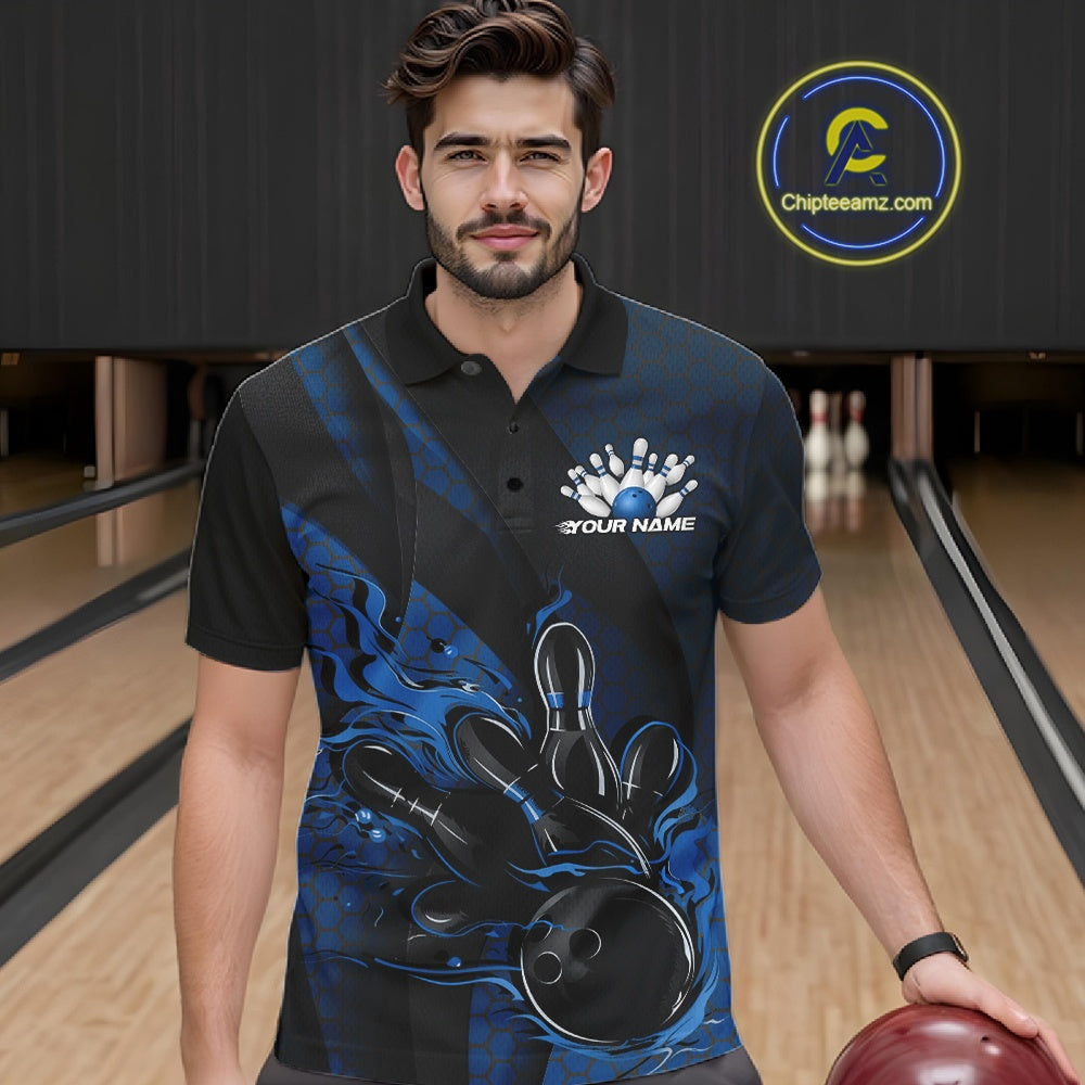 Male model at a bowling lane wearing a black and blue bowling polo shirt with fiery bowling artwork and geometric stripe accents.