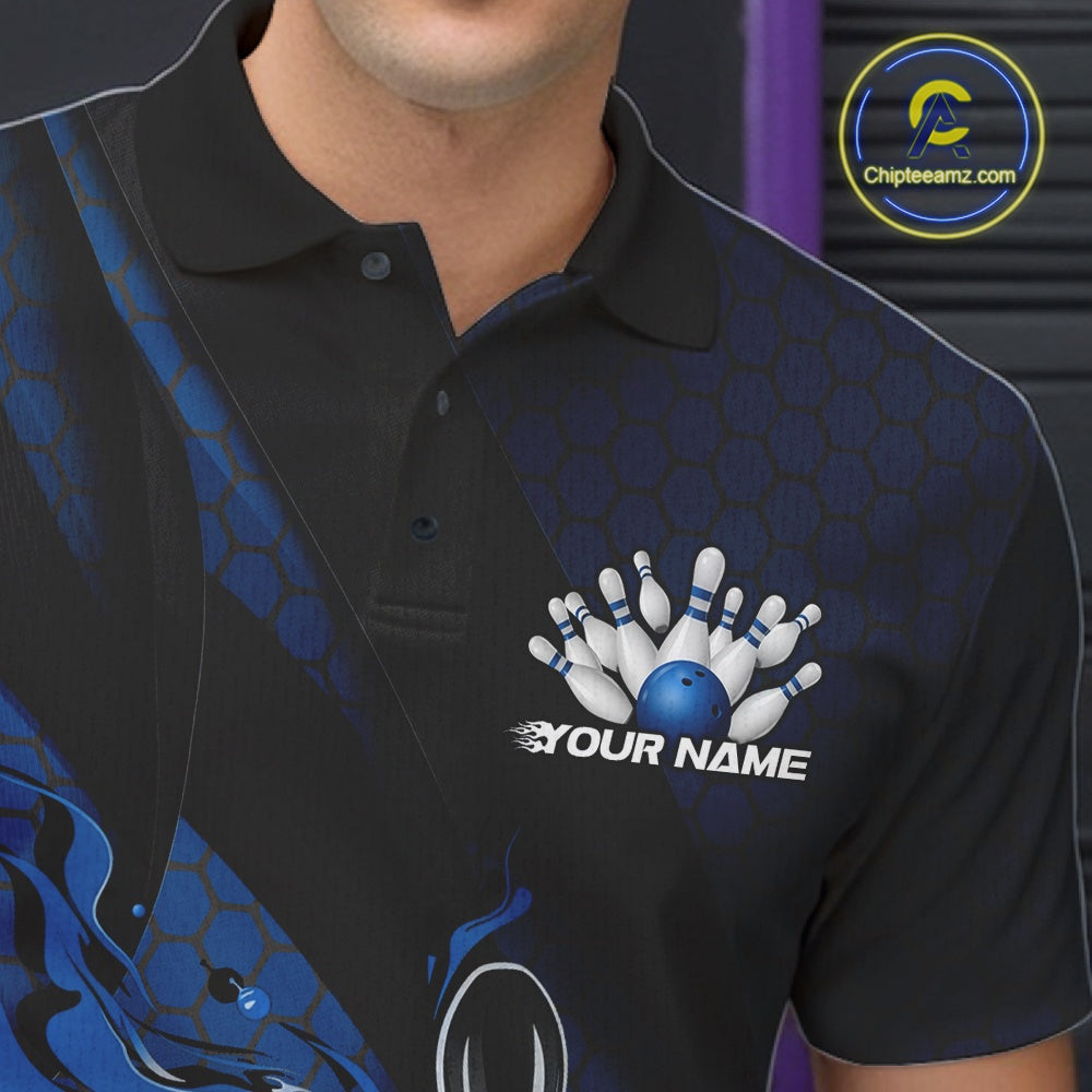 Close-up left chest detail of a black and blue bowling polo shirt featuring a flaming bowling ball striking pins with geometric accents.
