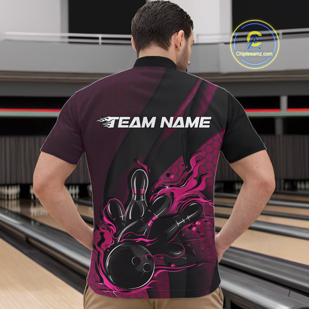 Front view of a male model in a bowling venue wearing a black and pink quarter-zip shirt featuring a flaming bowling ball hitting the pins.