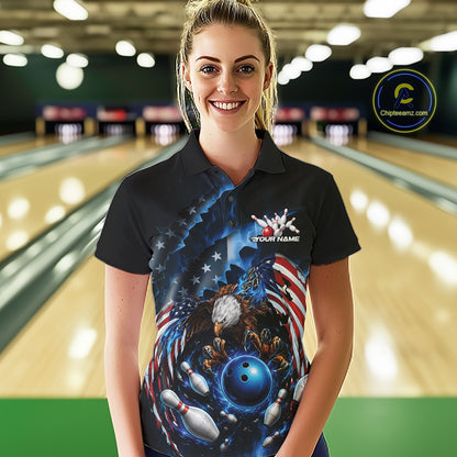 Front view female model at the bowling lane wearing a bowling polo shirt with bald eagle artwork, blue bowling ball, flying pins, and American flag background.