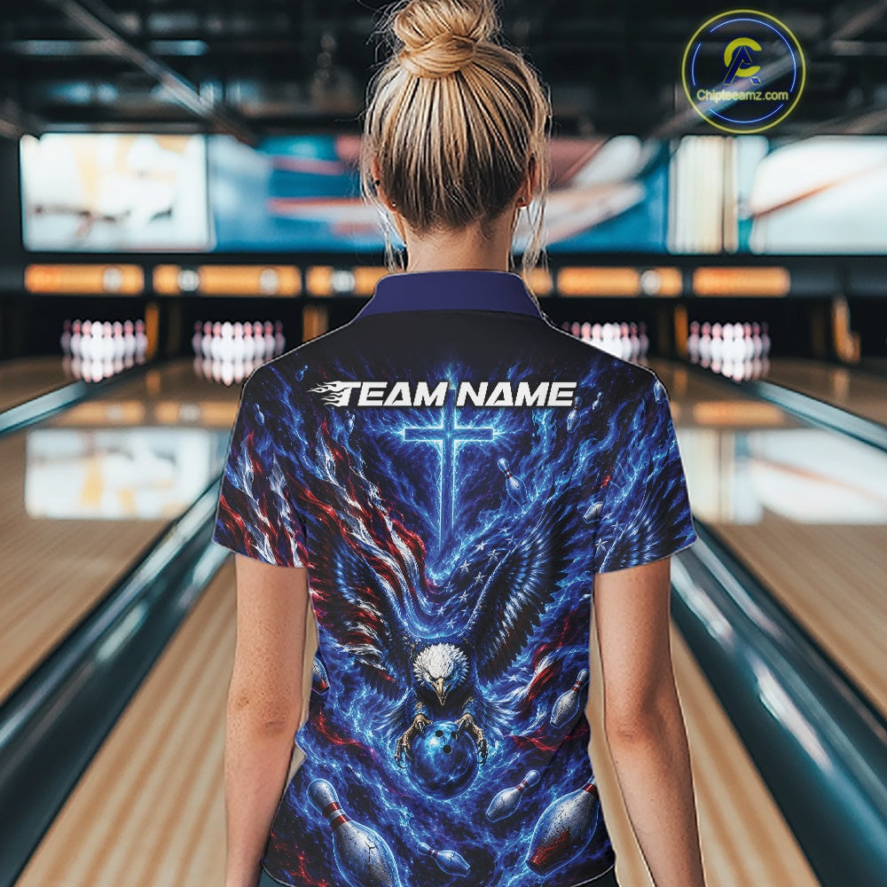 Back view of a female model at the bowling lane wearing a polo shirt with eagle artwork around a bowling ball, flag elements, and pins.