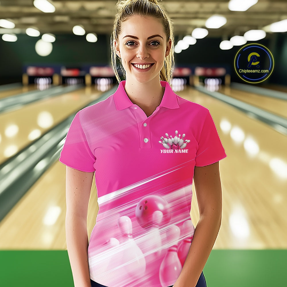 Front view female model in a bowling lane wearing a pink bowling polo shirt with bowling ball and pins blended into a geometric pattern.