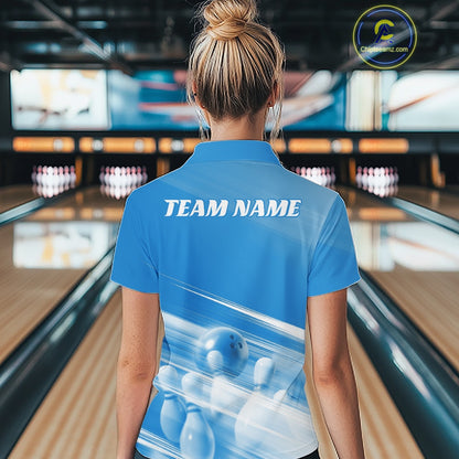 Back view of a female model at the bowling lane wearing a blue bowling polo shirt with bowling ball and pins geometric artwork.